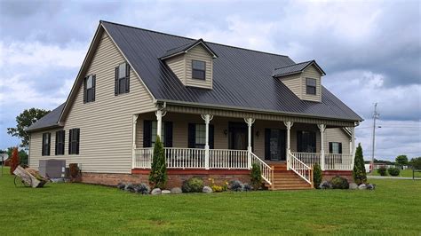 yellow house with metal roof|brown roof house color scheme.